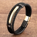 Multilayer black woven leather bracelet with gold metal accents on a wooden background - Black Braided Gold Clasp
