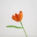 Handmade crochet orange lily flower with green stem and leaf in a knitted design - Blooming Tulip Orange