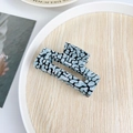 Blue and black leopard print hair claw clip made of acrylic on a wooden tray - 7.5cm / Teal Spots