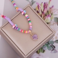 Bohemian colorful heishi bead necklace with purple heart pendant on jewelry box - Purple