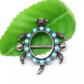 Macro view of vintage silver turtle body jewelry featuring turquoise beads and metal piercing bar - Turtle Turquoise Style