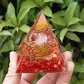 Orgonite pyramid with red stones and pink crystal sphere on green background - QK39 Pink Ball Red Coral