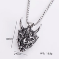 Macro shot of retro stainless steel demon eye pendant with detailed 3D carving - Vintage Silver Prajna Ghost Face Style