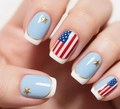 Close-up of Fourth of July press-on nails with stars, stripes, and 3D metallic charms - Light Blue French Gold Edge Stars (CW591)