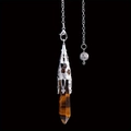 Macro shot of tiger eye stone pendant with silver filigree cap on dark background - Tiger's Eye