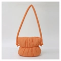 Detail of orange puffy cloud bucket bag showing soft quilted nylon fabric and strap - Orange
