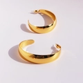 Polished gold-plated chunky C-shaped hoop earrings with a shiny metallic mirror finish - Gold