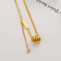Exquisite gold titanium steel necklace featuring a triple ring pendant and zircon detail - Cylinder Tassel