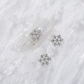 Silver snowflake nail art charms with embedded rhinestones on a sparkling manicure nail - Style A1143-07