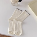 Vertical ribbed cream mid-calf socks with black trim and decorative side button - Contrast Color