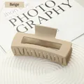 Matte beige large rectangular hair claw clip with cutout design on ripple stand - Beige
