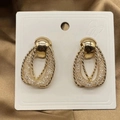 Close-up of golden mesh texture and twisted rope detail on interlocking teardrop earrings - Double Layer Crossover