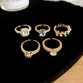 Detalle de cinco anillos chapados en oro con circonitas sobre terciopelo negro - Anillos abiertos de oro (5#) / Dorado (Juego de 5 piezas)