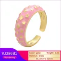 Detailed macro of a gold brass ring with pink enamel coating and star patterns - Pink Star