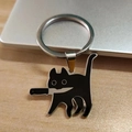 Quirky black stabby cat keychain in enamel finish with silver ring on wooden desk - Keyring (Pinch Bail)