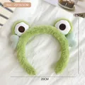 Detailed view of plush green frog headband with size 20x16.5cm on white fabric - 2# Green Eye Frog Headband