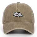 Close-up of cute cartoon seal embroidery on washed khaki vintage baseball cap - Khaki