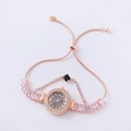 Detail of rose gold bracelet watch with pink rectangular gems and a black square dial - Rose Gold-Round Black Dial (Fadi)