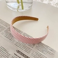 French style red and white checkered fabric headband displayed on a vintage newspaper - Pink Plaid