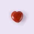 Red heart-shaped natural stone with polished finish and unique marble veins - Red Jasper