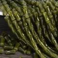 Detailed view of glossy green bamboo-shaped glass beads for DIY jewelry making and crafts - 6x12mm Olive Green (1Pc)