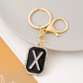 Luxury gold letter X keychain with black enamel and sparkling rhinestones on the pendant - Letter X