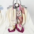 Detailed view of floral silk scarf in beige with purple border draped on a white shirt - Fuchsia Floral