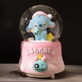 Pink Stitch musical crystal ball globe featuring a sleeping figure on an embossed resin base - 2513 Pink Base / Large 100mm Snow + Light