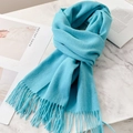 Teal pure wool scarf for winter with soft fringe details on marble surface - Lake Blue
