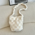 Close-up of a plush checkerboard shoulder bag in soft cream and beige faux fur texture - Plush White Plaid