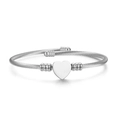 Detailed view of a silver heart-shaped pendant on a stylish twisted cable wire bracelet - Heart Pattern Style / Silver