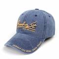 Close-up of golden embroidery and Bourbon St. text on a vintage washed baseball cap - Navy Blue