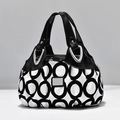 Women's handbag featuring black and white geometric patterns and glossy black handles - Black Geometric Circle