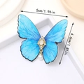 Elegante fermaglio a farfalla blu con strass dorati e pendente di perla bianca - Celeste