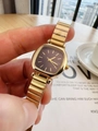 Close-up of golden square watch with dark dial on a wrist in a cozy setting - Gold Color Black