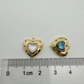 Macro shot of 18K gold heart charms with shells and scale for size reference - Zirconia Heart (Abalone Shell)
