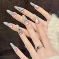 Uñas postizas almendradas ojo de gato moradas con purpurina plateada y pedrería - XS / Óvalo Largo