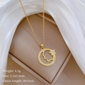 Detail of star and face silhouette gold necklace with crystal inlay on beige jewelry box - Star Moon Face Silhouette Pendant Stainless Steel Chain (C525)