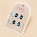 Detailed view of blue and black press-on nails with pearls and heart rhinestones - By1558 / Phototherapy Glue Style