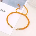 Adjustable vibrant orange braided Milan rope bracelet with golden metal beads finish - Orange