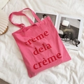 Sac fourre-tout en toile rose avec texte rouge sur fond de tissu blanc plissé - Rose Rouge