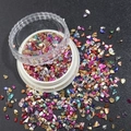 Macro shot of colorful irregular metallic foil flakes for nail art in a round clear container - 1.5-3MM Canned / Electroplated Mixed Colors