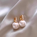 Detailed close-up of gold-plated floral pearl earrings on soft silk fabric background - Versatile Zircon Pearl Ear Buckles - A1400 White