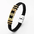 Macro shot of black braided leather bracelet featuring gold bat and fù character pendant - Bat Bat Pattern