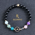 Detailed shot of Scorpio beaded bracelet with black stones and golden constellation charm - Scorpio-Obsidian