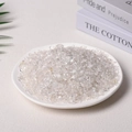 Polished natural clear quartz crystal chips displayed in a white ceramic dish - 100 Grams Of Ordinary White Crystal (5-7mm)