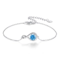 Elegant 925 sterling silver infinity bracelet featuring a central round blue gemstone - Platinum Plated Light Blue Gem Infinity Bracelet 1.97g