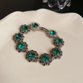 Close-up of vintage flower bracelet with green gemstones and sparkling rhinestones - 12# Bracelet - Green - Flower