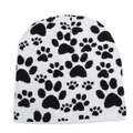 Cozy white knitted beanie hat with stylish black paw print patterns for winter warmth. - One Size / White
