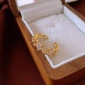 Detail of gold-plated adjustable ring with star-shaped zircons on a luxury wood box - 17# Ring - Gold - Star Design